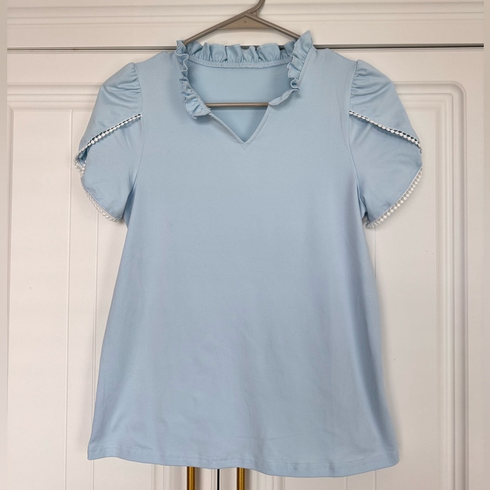 Sky Blue Ruffled Kids Blouse fits like a woman’s small